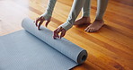 Hands, yoga mat and unroll for workout, fitness and wellness start for health or weightloss. Person, wooden floor and exercise with training, meditation and zen for peace and holistic mindfulness
