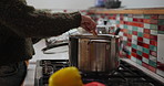 Person, hand and cooking pot in kitchen for food meal prep in home or nutrition, stirring or healthy. Stove, spoon and lunch recipe for hungry diet with vegetables in apartment, vitamins or boiling
