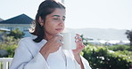 Coffee, relax and Indian woman on balcony in morning with beverage, latte and caffeine for breakfast. Hospitality, hotel and happy person with drink on holiday, vacation and weekend for calm outdoors