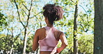 Person, running and fitness in park with exercise, workout and wellness for health journey from back. Young runner or jogger with sports training, jogging and energy and cardio in nature and outdoor