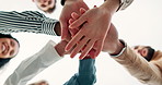 Business people, meeting and hands together with motivation below for collaboration or mission on a white background. Low angle or closeup of young employees touching in teamwork, unity or solidarity