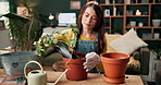 Home, gardening and woman with planting pot, soil and seeds with a gardener with spade for growth. Calm, leaves and eco friendly in a living room on a sofa with planting tools and care in house