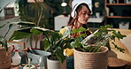 Girl, gardening and headphones in home with plant for growth, healing properties and connection to nature for wellness. Woman, music and calm in house for flora care in living room for natural decor.