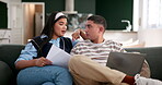 Accounting, documents and laptop with couple on sofa in living room of home together for budget. Finance, investment or savings on computer with man and woman in apartment for payment or tax review
