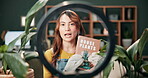 Woman, house and plant with influencer in home, living room and botany book with knowledge info. Ring light, eco friendly and growth for gardening channel, content creator and organic ecology