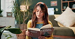 Book, plants and reading with woman on living room floor for information, learning or research. Gardening, how to and study with person in home apartment for green hobby, horticulture or leisure