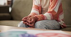 Hands, girl and nervous on sofa with anxiety, stress and scared while scratching fingers. House, living room and child with hand gesture on couch with worry, sitting and depression of kid in lounge