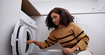 Woman, washing machine and laundry in home with clothes for cleaning hygiene, housekeeping or chores. Female person, fabric and appliance or detergent routine in apartment or basket, linen or dirty