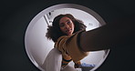 Remove, woman and clothes for washing in machine at home after cleaning, tidy and housekeeping. Female cleaner, laundry or fabric and cotton in electronic appliance, dryer and routine in apartment
