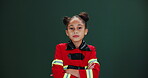 Little girl, face and costume in studio with mockup or green background for halloween, cosplay and dress up for party. Child, serious and confident for career day at school in fire fighter outfit.