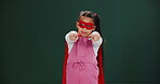 Child, costume and girl as superhero in studio pointing for halloween promo or mockup space. Comic, character and kid in cosplay a villain in fashion with power, confidence and pride in identity