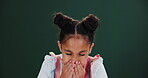 Sick, child and girl sneeze in studio for allergy, illness or hay fever on green background. Health, virus and hands of young kid with stuffy nose for sinus issue, bacteria or flu symptoms on mockup