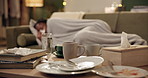 Messy living room, sick and woman on sofa with coffee cup, plate and dirt with flu, covid or virus. Girl, African person and dishes on lounge table with sneezing, cough and night with tissue in home