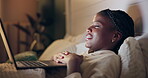 Bed, watch and black woman on laptop for movie streaming service, film or comedy at night. Girl at home relax in bedroom with computer for online TV show, series and funny video on weekend or holiday