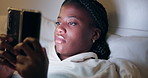 Night, rest and black woman with phone on bed for online chat, communication and networking. Relaxing, home and tired person on smartphone for social media, website and internet news in bedroom