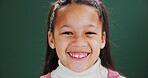 Happy, child and face of girl in studio on green background with excited energy or back to school. Education, portrait and kid at academy for learning or growth of gen z student with style or fashion