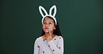 Easter, bunny and girl in studio thinking of promotion, announcement or question on mockup. Holiday, sale and kid remember info in dark background, space for ideas or vacation with fashion or costume