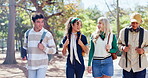 Friends, diversity and outdoor as people, walking and backpacks with smile, campus or university. Students, happy and talking for exam, education and scholarship in learning, college or school in USA