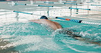Swimming pool, fitness and swimmer in professional, gym and race lines for competition as athlete in training. Aquatic sports, person and workout in underwater for cardio, activity or exercise
