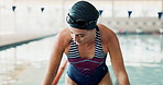 Swimming pool, swimmer and swimwear in professional, gym and practice for competition as athlete or training. Female person, aquatic sports and workout in underwater for cardio, activity or exercise
