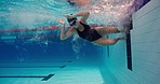 Pool, sports and flipturn for exercise, swimmer and freestyle stroke for practice. Underwater, professional and swimwear for female athlete in water, train and competition and cardio workout routine