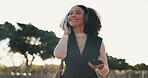 Cellphone, woman and headphone for work commute, music and urban area for travel. Smile, morning and lens flare for happy female person, professional and outdoor for audio entertainment at sunrise