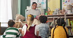 Kindergarten, children and teacher reading a story in montessori school, classroom and learning. Kids, fairytale and woman teaching language with creative fantasy stories in preschool education