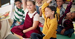 Children, teacher and hands up in classroom for reading question or back to school, learning or education. Kids, group and friends on floor for storytelling knowledge or library, growth or studying