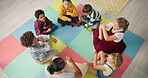 Kindergarten, kids and hands with game in circle for child development, growth or activity. High angle, diversity and playful student on mat in class for sensory learning, education or creative skill