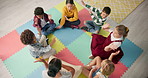 School, kids and teacher with game in circle for child development, activity and growth. High angle, hands and playful student on mat in kindergarten for sensory learning, creative skill or education
