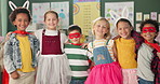 Happy kids, friends and hug with costume in class for dress up or casual day at school together. Portrait of young group with smile for halloween in cosplay outfit, hero or fairy tale in classroom