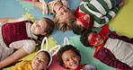 Happy children, friends and costume in class above on floor for dress up or casual day at school. Top view, portrait or young kids with cosplay outfit, hero or fairy tale in halloween classroom