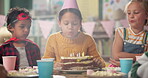 Birthday party, classroom and children with blowing of candles for special event, development and growth of child. Happy, friends and smile with cake at school table for celebration, support and love