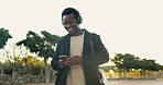 Black man, outdoor and dancing on smartphone with headphone for music playlist with smile for entertainment in Atlanta. Happy, commute and internet for streaming platform with song or album and video