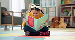 Girl, school and reading book in classroom, childhood development and growth for vocabulary in kindergarten. Happy, smile and knowledge or information with storybook, learning and fantasy for child