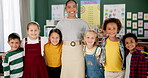 Face, students and happy teacher at kindergarten in classroom, bonding and education. Learning, portrait and group of children smile, funny and laughing for knowledge, study and development at school