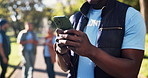 Black man, hands and volunteer with phone for communication, social media or chatting in nature. Closeup of African or male person typing on mobile smartphone for online texting, research or app