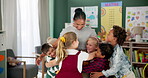 Happy woman, kids and hug teacher at school for learning, education or development in class together. Smile, group and children embrace educator in kindergarten for diversity, study or playing game