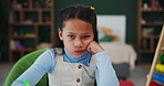 Girl, face and frustrated with school, writing and assignment for education and learning. Student, classroom and mad for knowledge, homework and mental development for skills and kindergarten