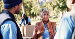 Women, volunteer and discussion with clipboard in park for community service, planning and support. NGO, idea and mature manager with teamwork in nature for charity project, collaboration or donation