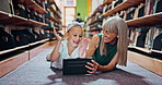 Mature woman, tablet and girl with high five on library floor for ebook, score and happy or excited. Grandma, technology and child for learning, knowledge and development with digital app or game