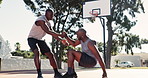 Basketball, help and men on outdoor court together for game, solidarity and fitness in park. Sports, support and friends on playing with teamwork, community and professional respect on playground.
