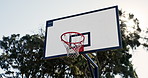 Basketball, hoop and sports with sun in playground for game, match or outdoor competition. Closeup of empty turf, backboard or circle with net in sunshine or nature for tournament, score or point