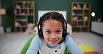 Little girl, face and headphones in home for video gaming, internet learning and homeschooling with cyber school for digital literacy. Child, portrait and virtual courses for education knowledge.