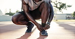 Sports, tie shoes and hands on basketball court to start training, cardio workout or game. Athlete, legs and black man fix trainers for preparation, exercise or getting ready in outdoor park of Miami