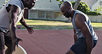 Friends, basketball court and men with practice in park for sport, coaching and help in training. Summer, black people and energy with challenge in nature for fitness, exercise and workout in Chicago