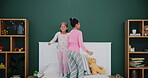 Sisters, bedroom and jumping with laughing in pyjamas for fun with sleepover for child development in house. Active, cheerful and siblings for happiness on weekend with love for family with funny.