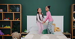 Sisters, bedroom and laughing with jumping in pyjamas for fun with sleepover for child development in house. Siblings, cheerful and active with happiness on weekend for love with family for fun.