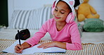 Child, headphones and girl with notebook in home, music and drawing or writing on bed for childhood development. Growth, creative sketch and education homework, online streaming and audio or listen