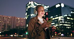 Woman, outdoor and smile on smartphone with headphone for music playlist, entertainment at night in New York. Female person, happy and internet for streaming platform with song or album and video